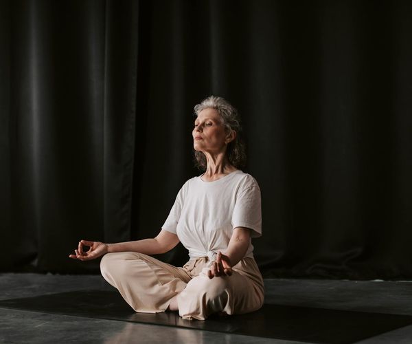 Close up of hands in a mudra position during a meditation session.