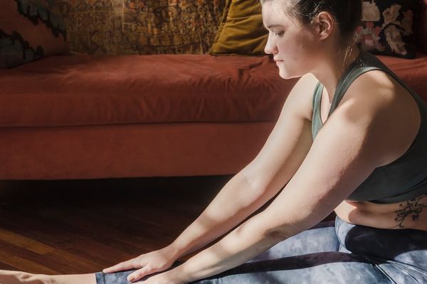 Warm morning sunlight hitting a yoga mat on a wooden floor.